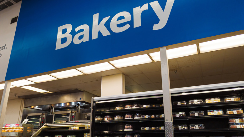 Bakery section with large blue sign and rows of displayed cakes inside Sam's Club store