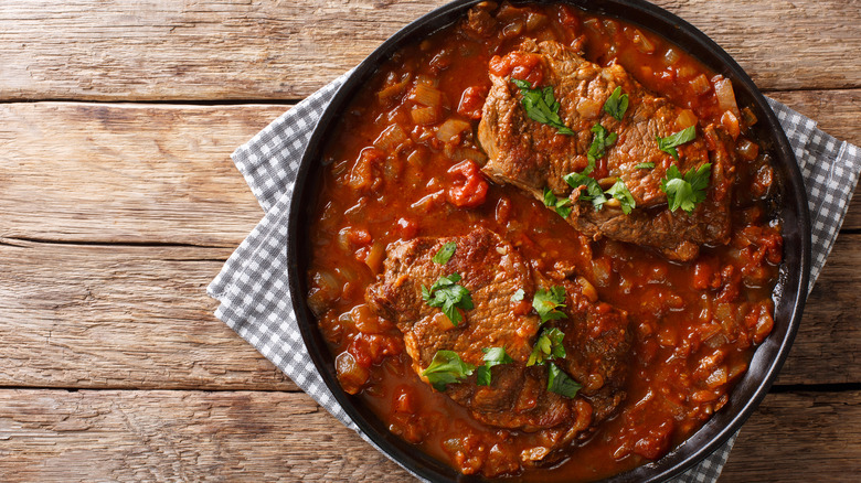 smothered swiss steak in a skillet