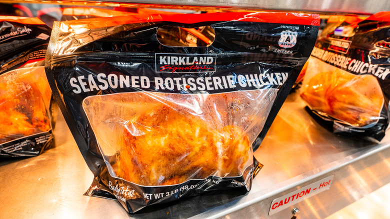 Bags of Kirkland Signature Seasoned Rotisserie Chicken on heating tray