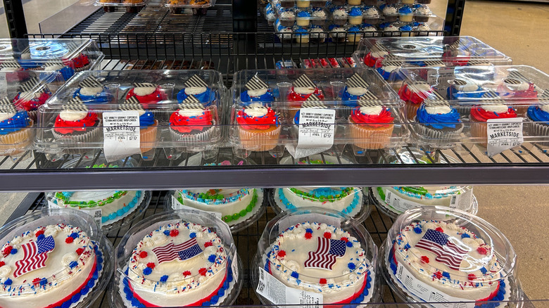 Marketside cakes and cupcakes displayed on a metal Walmart shelf