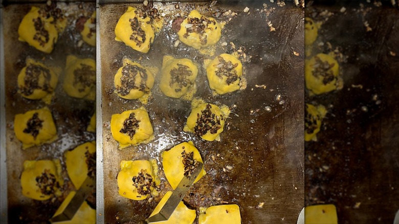 Burgers being prepared on a griddle at Gray's Hall