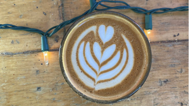 Overhead view of latte from Pablo's Coffee on a wooden table