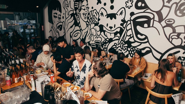 People dining inside Jilli by the black-and-white mural