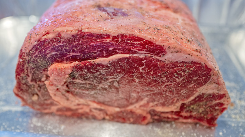 Raw prime rib roast that's been seasoned