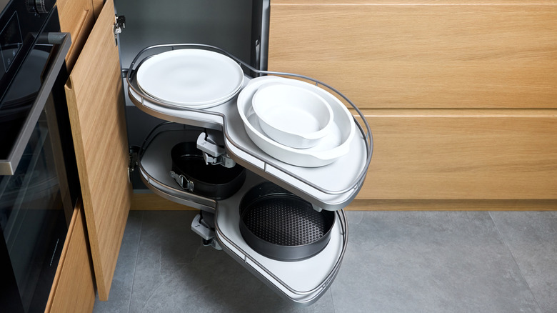 A magic corner kitchen cabinet organizer pulled half out to show the inside of how it works