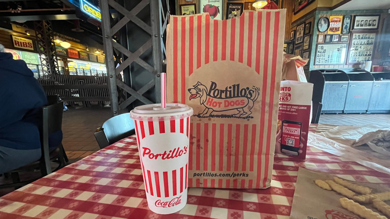 A cup and takeout bag for Portillo's Hot Dogs in Chicago