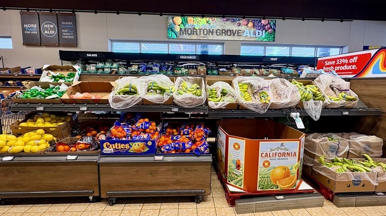 The produce section at Aldi, displaying various fruit in cardboard boxes
