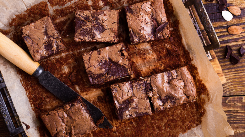 Pan of sliced brownies with knife
