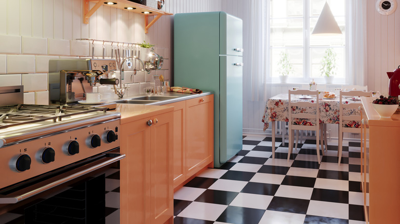 A small kitchen with white and black checkered linoleum floors