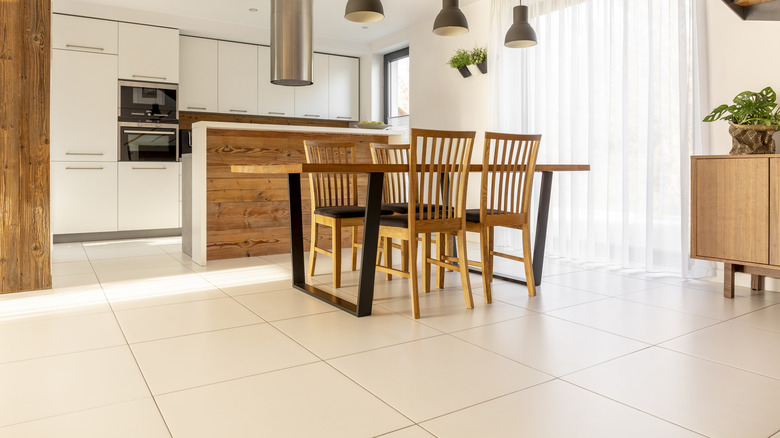 Large open kitchen with wood accents and white tile floors