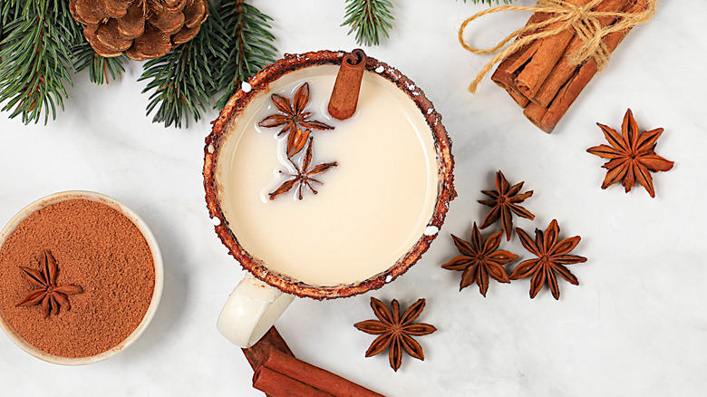 Eggnog with pine branches, cinnamon sticks