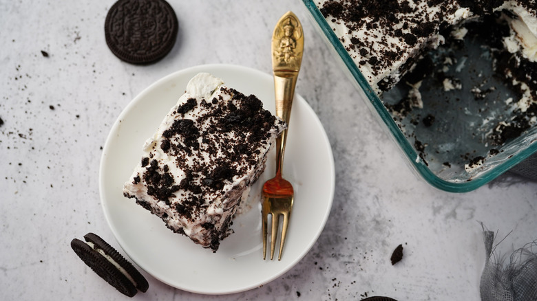 plated Oreo icebox cake, fork, cookies, glass casserole cake