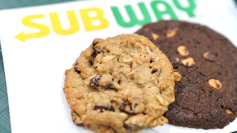 An oatmeal raisin and a double chocolate cookie from Subway on a Subway napkin