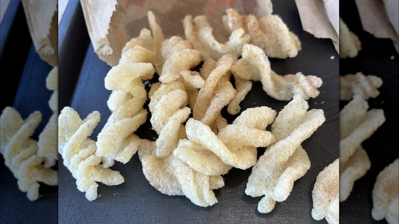 Bag of Taco Bell cinnamon twists on brown parchment paper on a black table