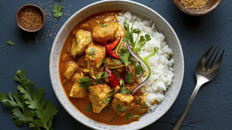 Rice bowl with chicken, peppers, cilantro, brown sauce