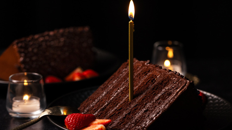 Cake slice from P.F. Chang's with a lit birthday candle