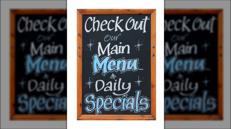 Cafe advertisement sign saying check out our main menu and daily specials
