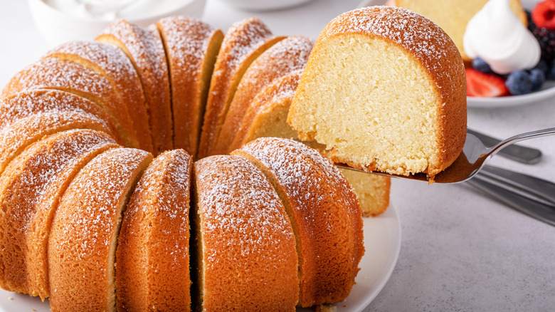 Vanilla Bundt cake with a slice being cut and served