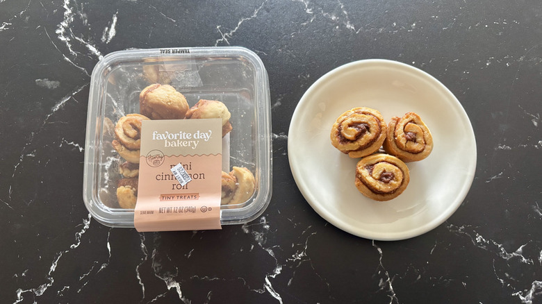Target's Favorite Day Bakery Mini Cinnamon Roll Tiny Treats in its container next to plate with three rolls