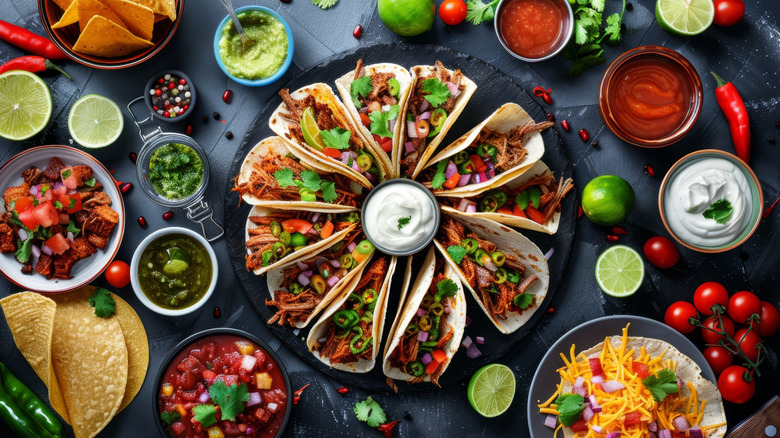 Platter of tacos with sour cream in the center