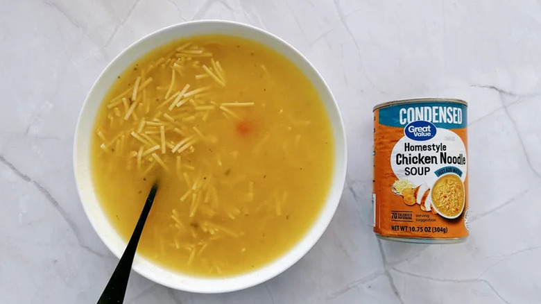 Can of Great Value's Homestyle Chicken Noodle Soup next to a bowlful