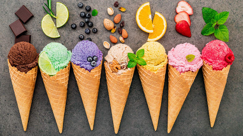 Colorful ice cream on cones with ingredients