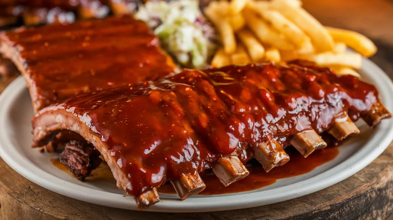 barbecue ribs on plate with fries and coleslaw