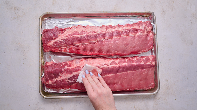 patting ribs dry with paper towel