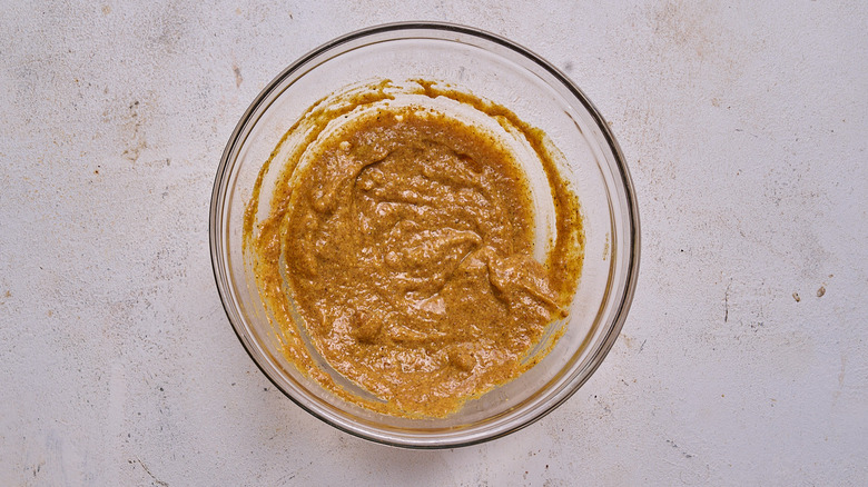 combining mustard and seasonings in bowl
