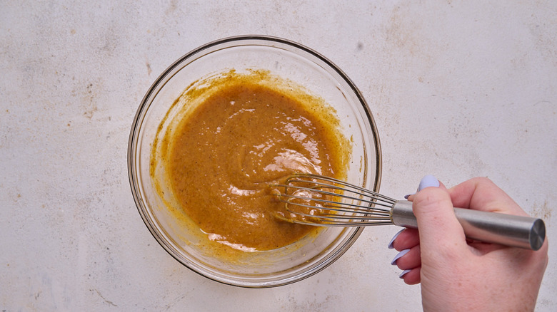 whisking oil into mustard