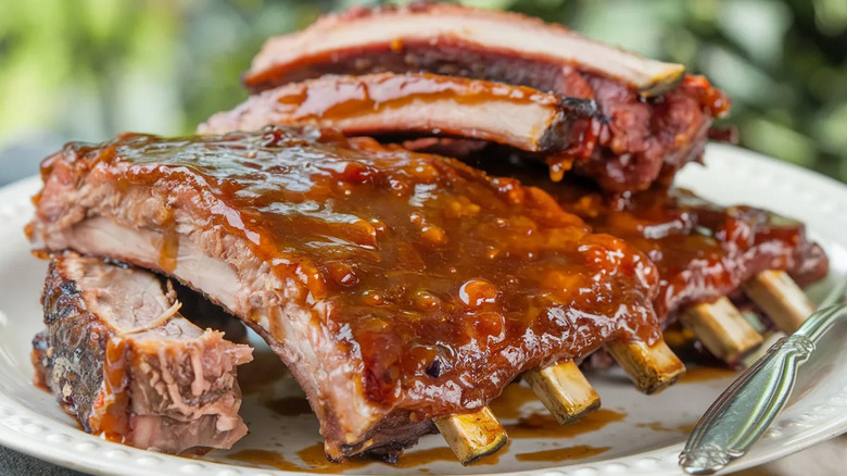 Cooked baby back ribs smothered in sauce