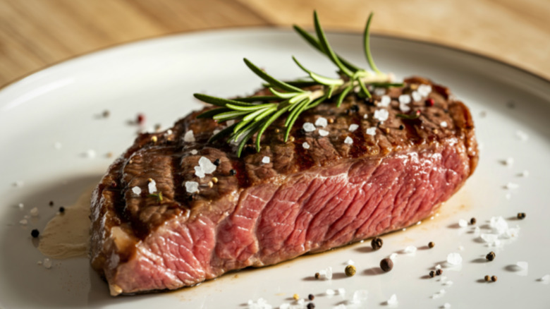 Seared steak on plate with rosemary