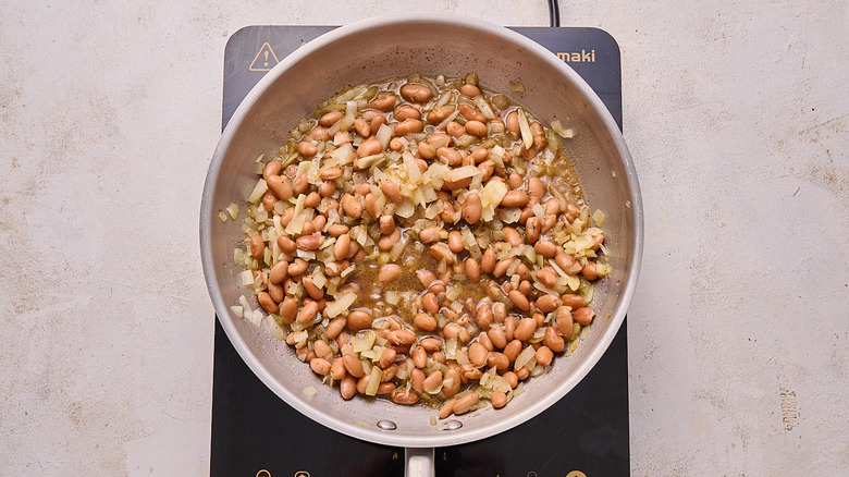 simmering beans in a skillet