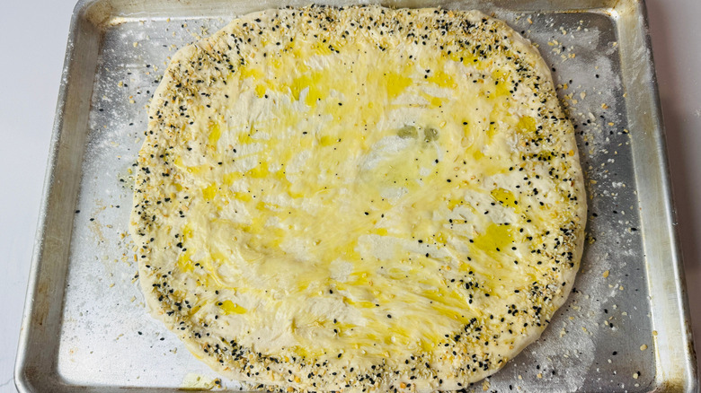 Pizza dough with olive oil and everything bagel seasoning crust