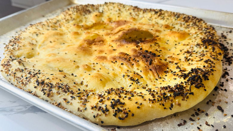 Baked everything bagel pizza crust on baking sheet