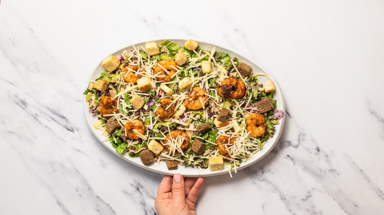 Serving platte with Baja shrimp Caesar salad.