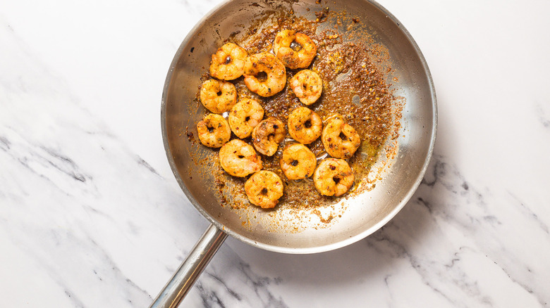 Cooked shrimp in pan.
