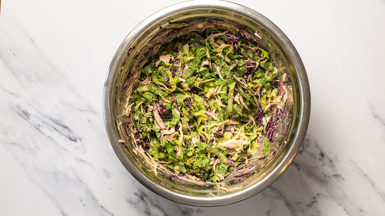 Dressed salad greens in large bowl.