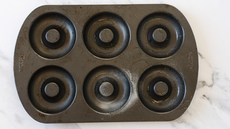 Greased donut pan.