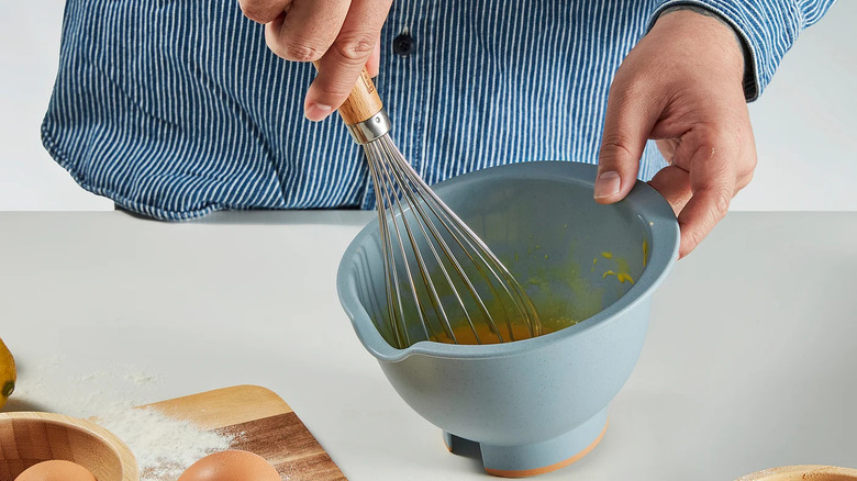 A baker whisking eggs in the Ponnyfisk mixing bowl