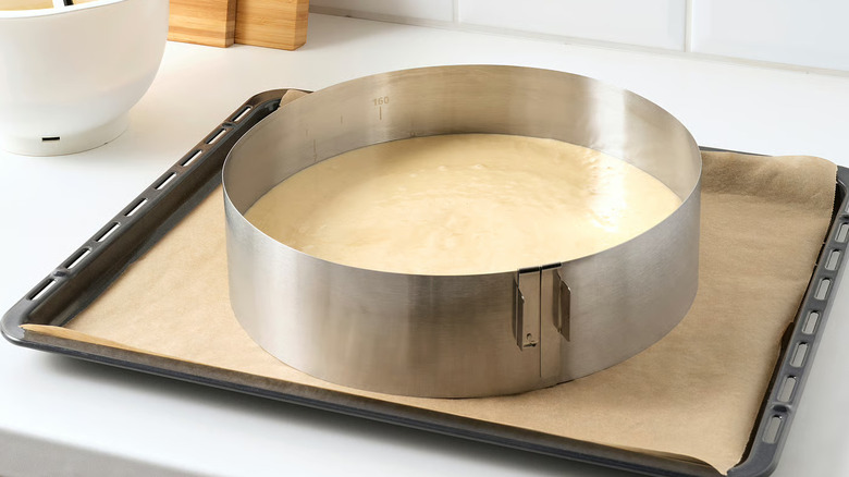 Cake batter in an adjustable, round baking frame