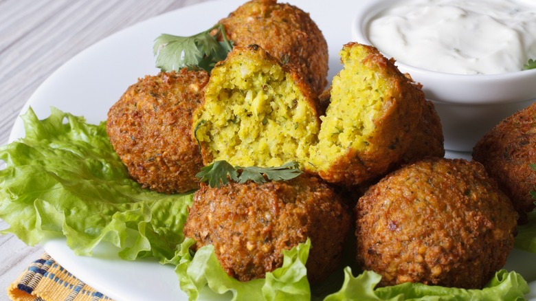 falafel, lettuce, and tzatziki sauce on a plate