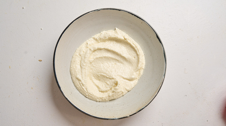 Whipped feta spread into a bowl