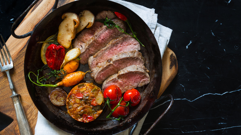 Roast beef with vegetables in a pan