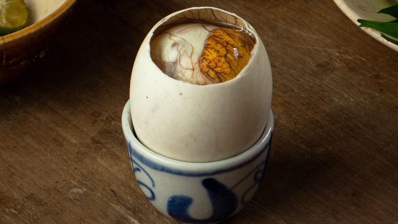 Close-up of balut duck egg in a small blue and white dish