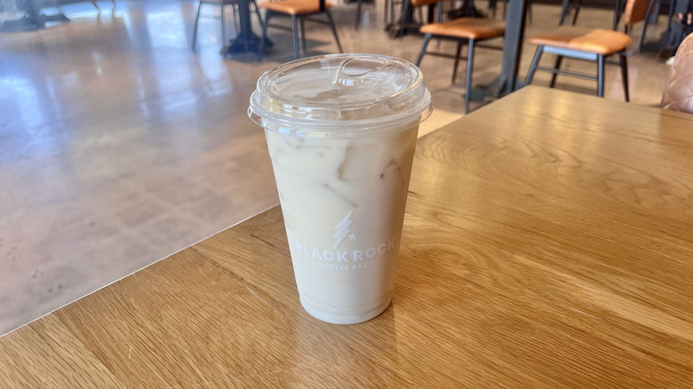 Black Rock Iced Chai with Banana on a table at a coffee bar served in a plastic cup