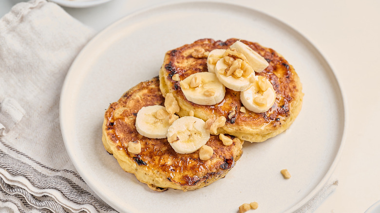 two pancakes on a plate with bananas
