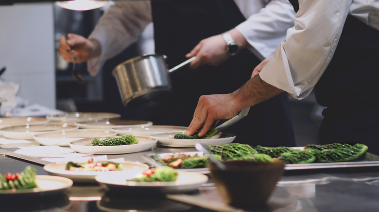 behind the scenes of a restaurant kitchen with chefs preparing meals