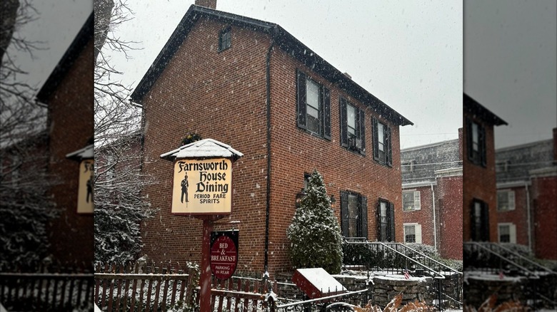 Brick building exterior of the Farnsworth House Inn on a snowy day
