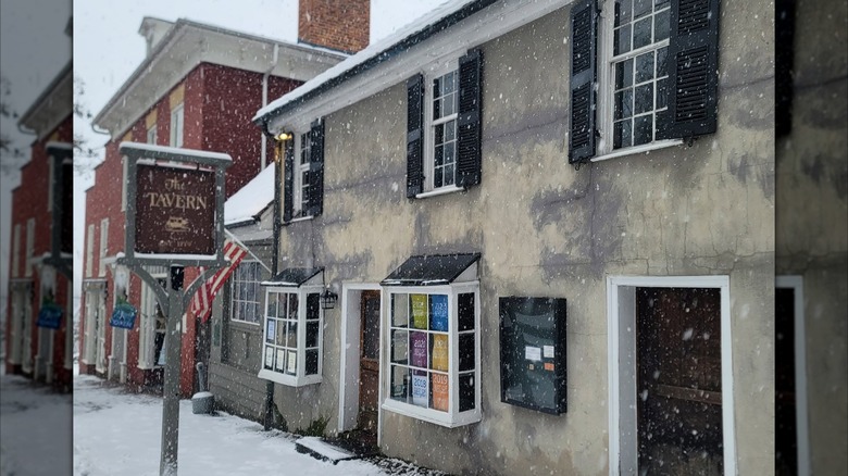 Exterior of The Tavern stone building on a snowy day
